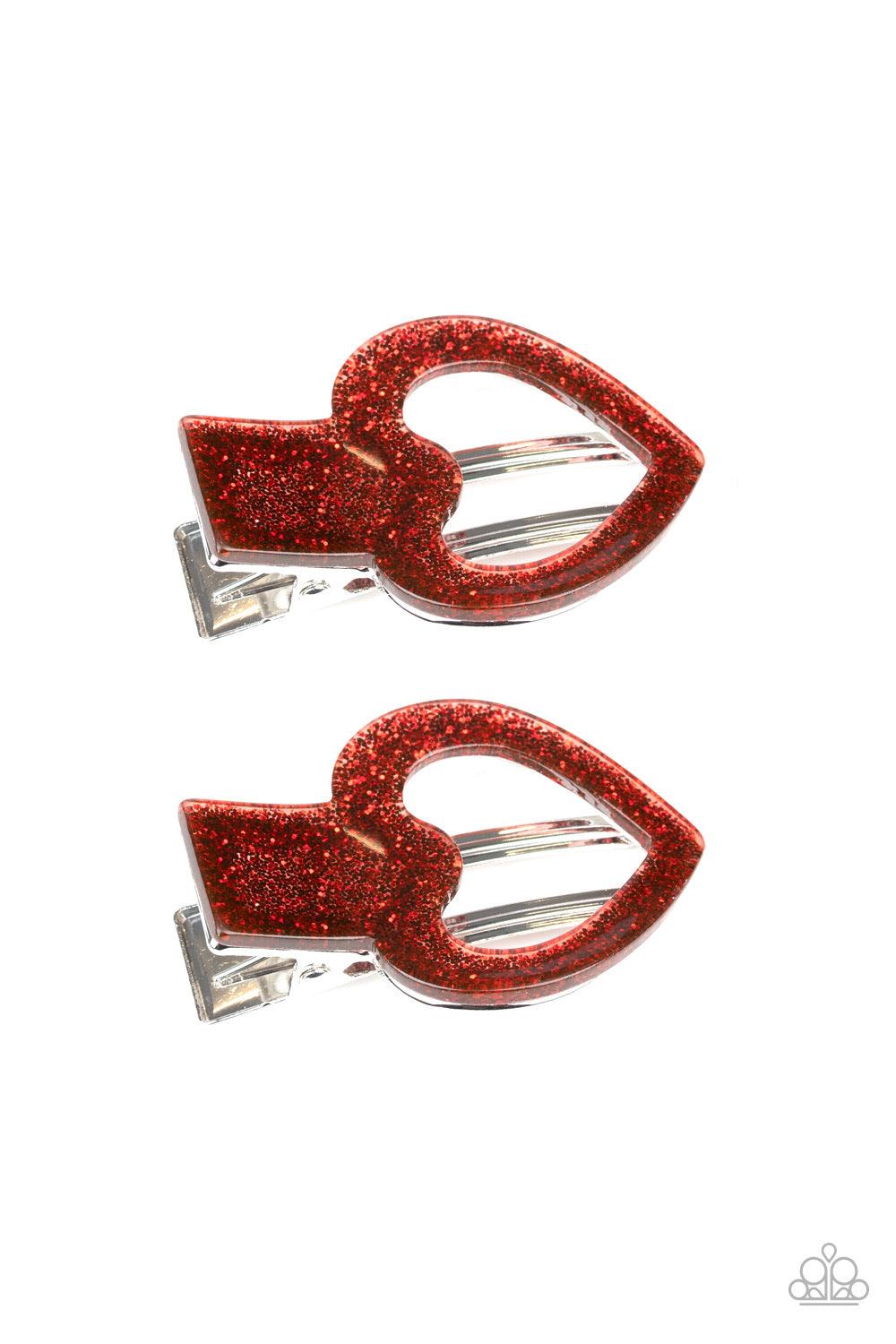 Paparazzi Accessories Glitter-Hearted ~Red Filled with red sparkles, glittery heart-shaped acrylic frames pin back the hair for a charming look. Features a standard hair clip on the back. Color may vary.