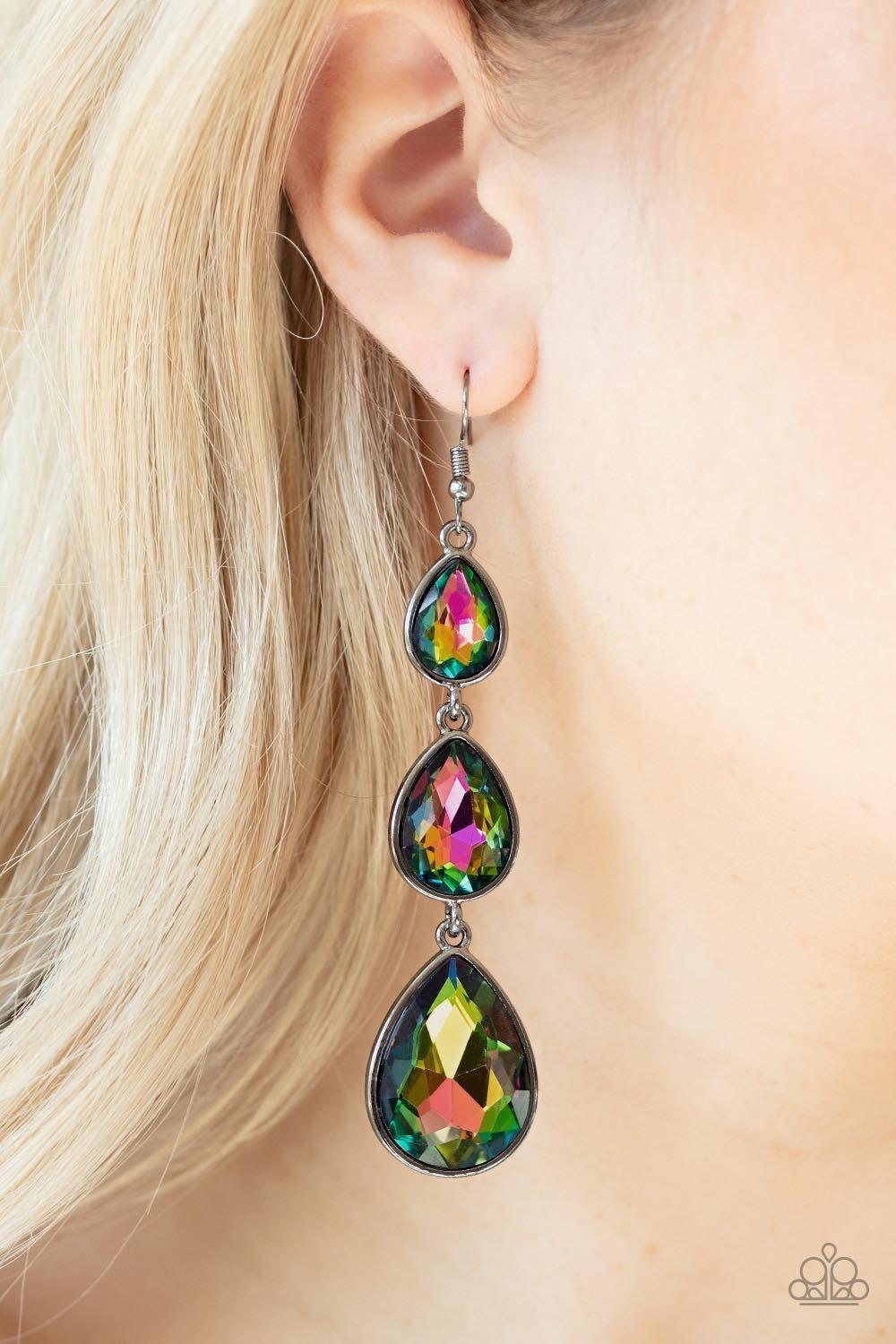 Paparazzi Accessories Metro Momentum - Multi Featuring sleek gunmetal frames, exaggerated oil spill teardrop rhinestones gradually increase in size as they drip from the ear. Earring attaches to a standard fishhook fitting. Jewelry