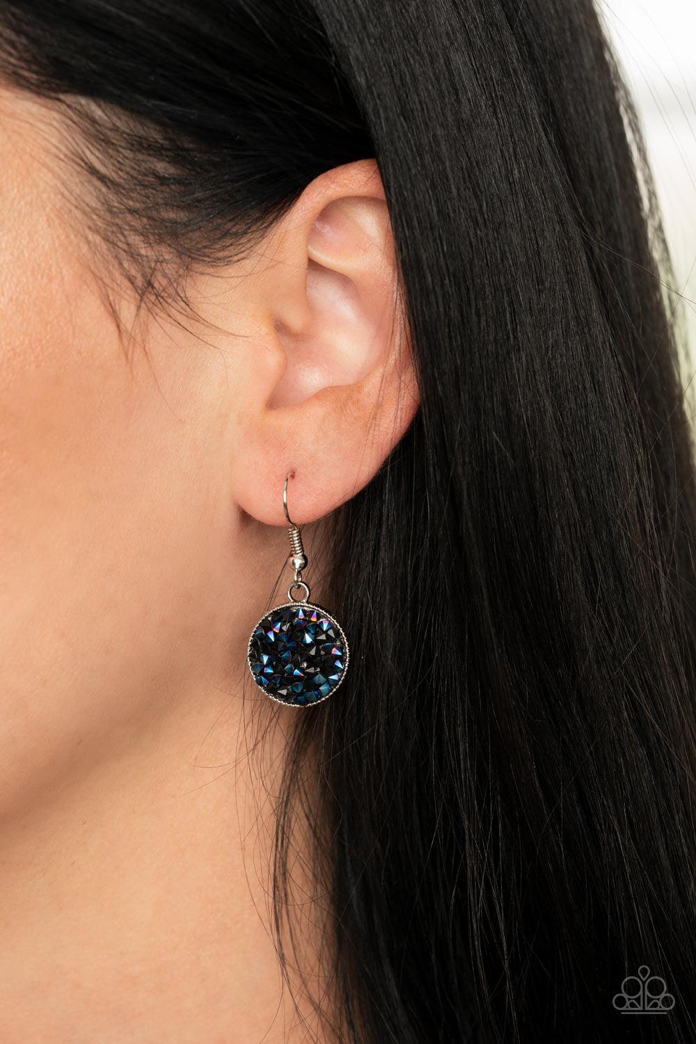 Paparazzi Accessories My Moon And Stars - Blue A smoldering collision of black and metallic blue rhinestones are encrusted across the front and back of a textured silver disc below the collar. Threaded along a dainty rod, the glittery pendant effortlessly