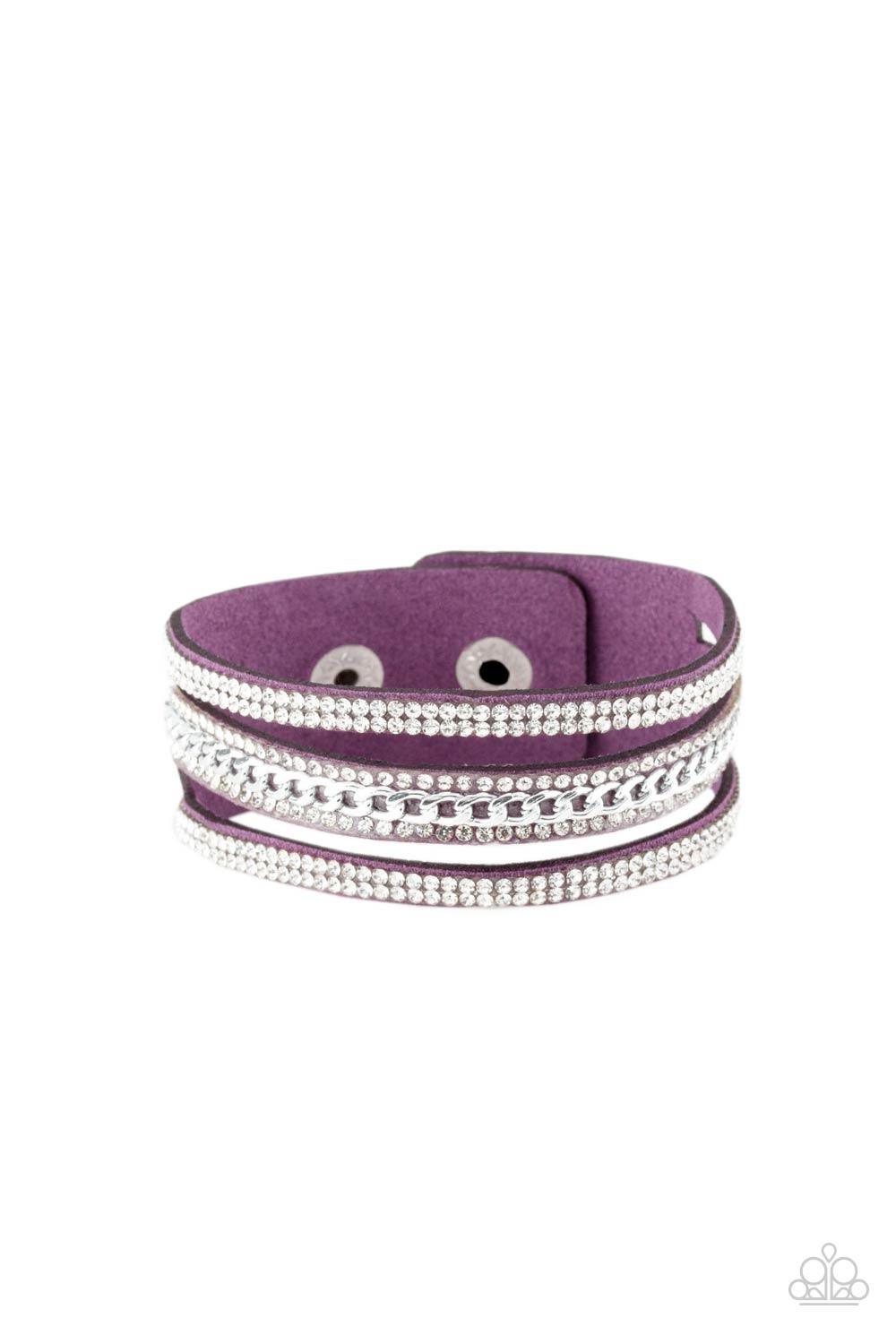 Paparazzi Accessories Rollin’ In Rhinestones - Purple Rows of glassy white rhinestones and a shimmery silver chain are encrusted along vibrant purple suede bands for a sassy look. Features an adjustable snap closure.Sold as one individual bracelet. Jewelr