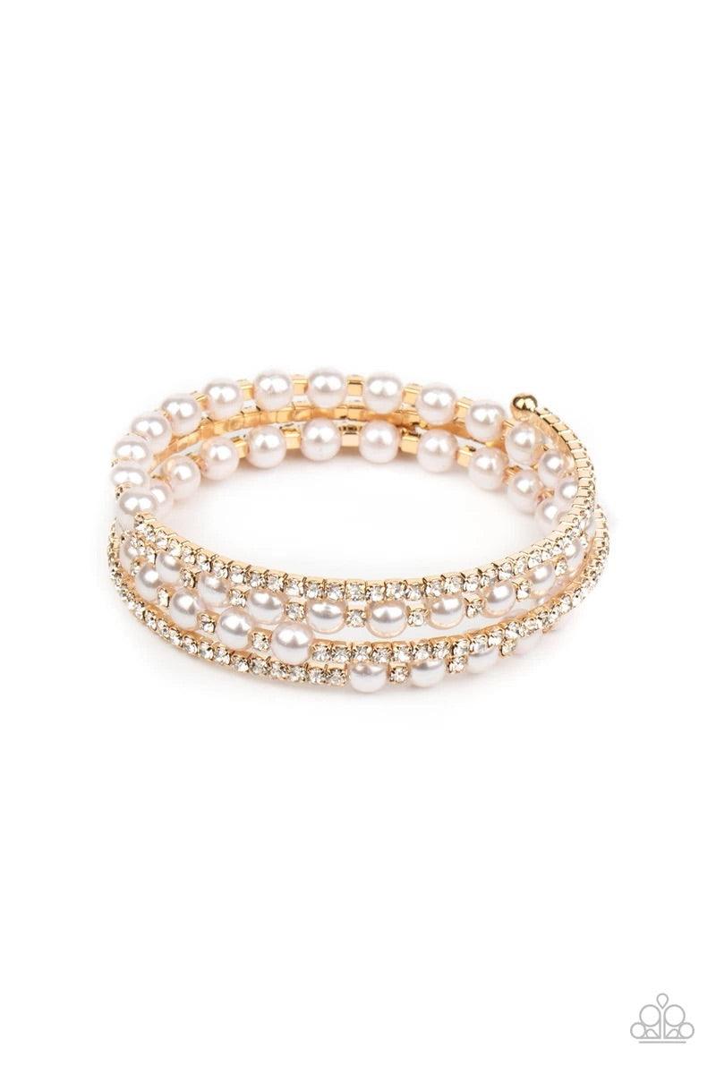 Paparazzi Accessories Starry Strut - Gold Row after row of glassy white rhinestones and classic pearls coil around the wrist, creating a blinding infinity wrap bracelet. Sold as one individual bracelet. Jewelry