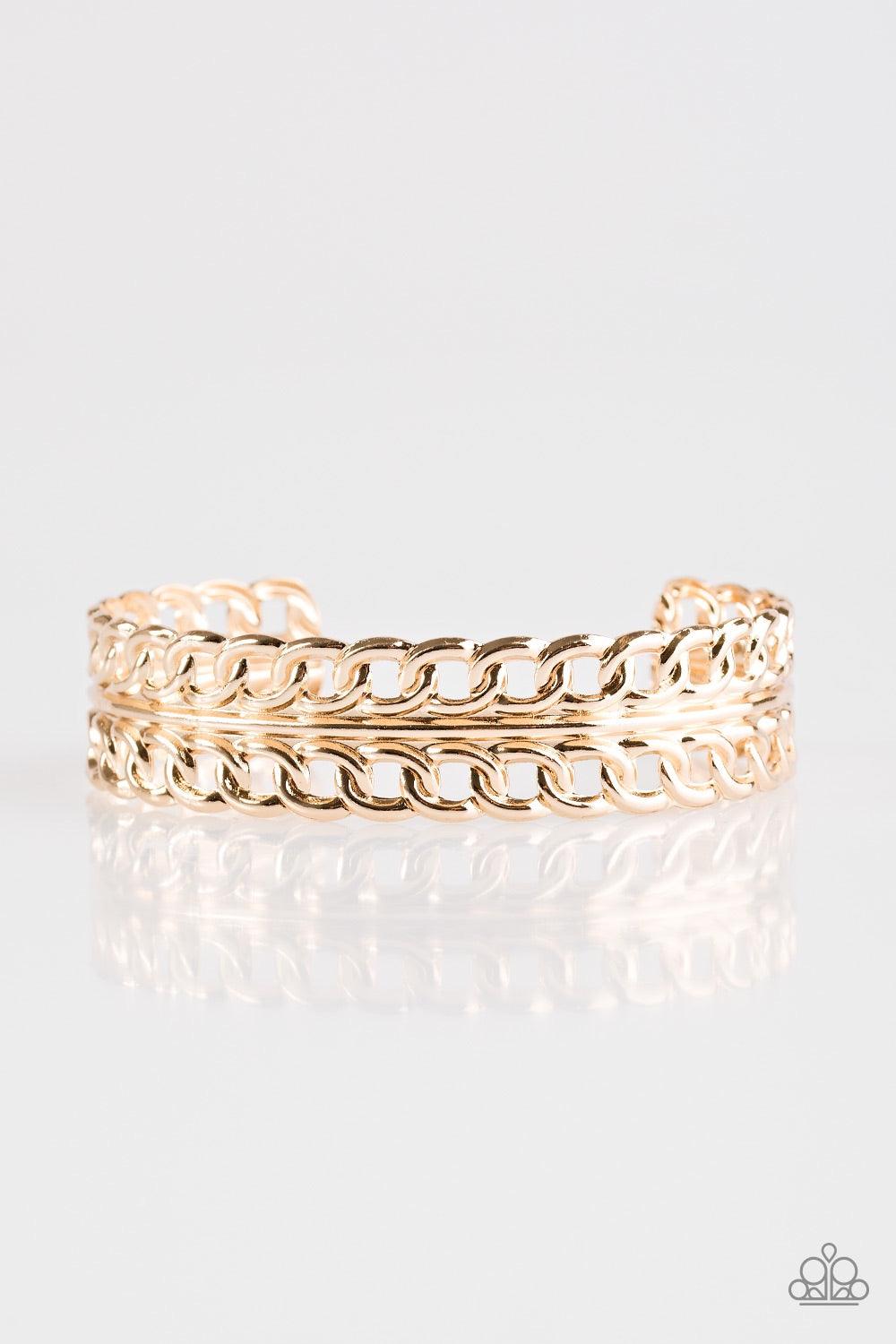 Paparazzi Accessories Progressive Movement - Gold Glistening rows of silver chain link stack across the wrist, coalescing into a bold industrial cuff. Jewelry