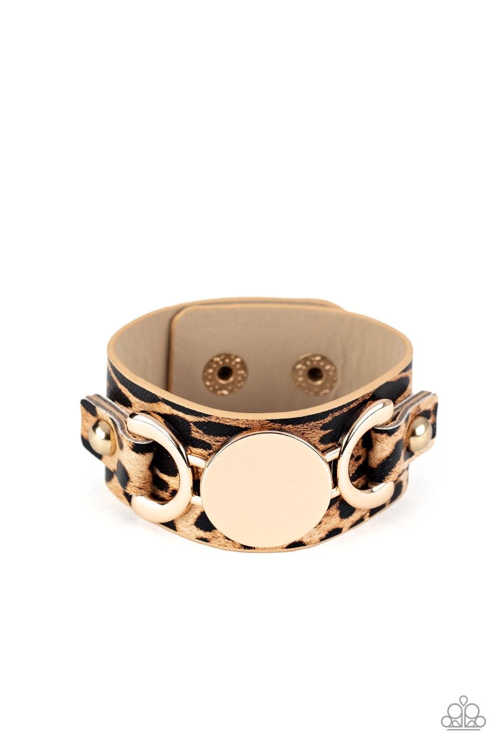 Paparazzi Accessories Your Claws Are Showing - Gold A golden buckle-like centerpiece is studded in place across the front of a thick leather band painted in brown cheetah print. Features an adjustable snap closure. Sold as one individual bracelet. Jewelry