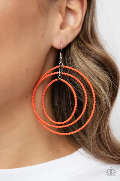 Paparazzi Accessories Colorfully Circulating - Orange Three oversized rings of dainty orange seed beads ripple into colorfully layered hoops, resulting in a dizzying display. Earring attaches to a standard fishhook fitting. Sold as one pair of earrings. J