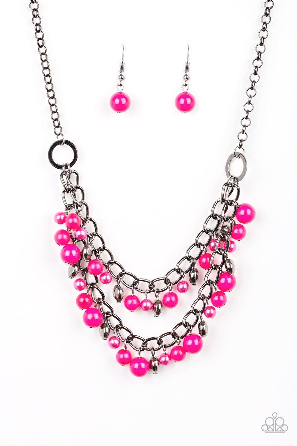 Paparazzi Accessories Watch Me Now - Pink Pearly and polished pink beading joins faceted gunmetal beads along a bold gunmetal chain, creating a sassy fringe below the collar. Features an adjustable clasp closure. Sold as one individual necklace. Includes