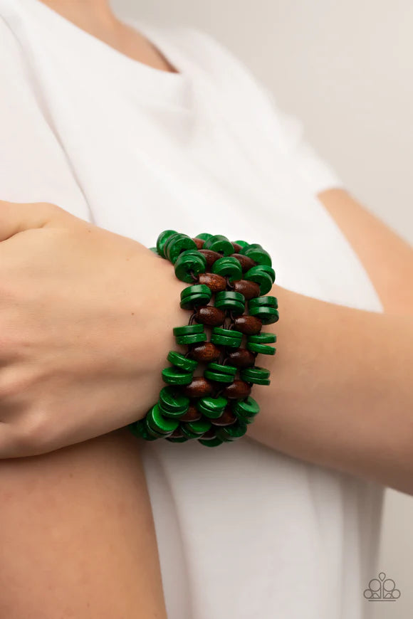 Paparazzi Accessories Galapagos Go-Getter - Green A tropical collection of distressed green wooden discs and brown oval wooden beads are decoratively threaded along stretchy bands around the wrist, creating a refreshing pop of summery fun. Sold as one ind
