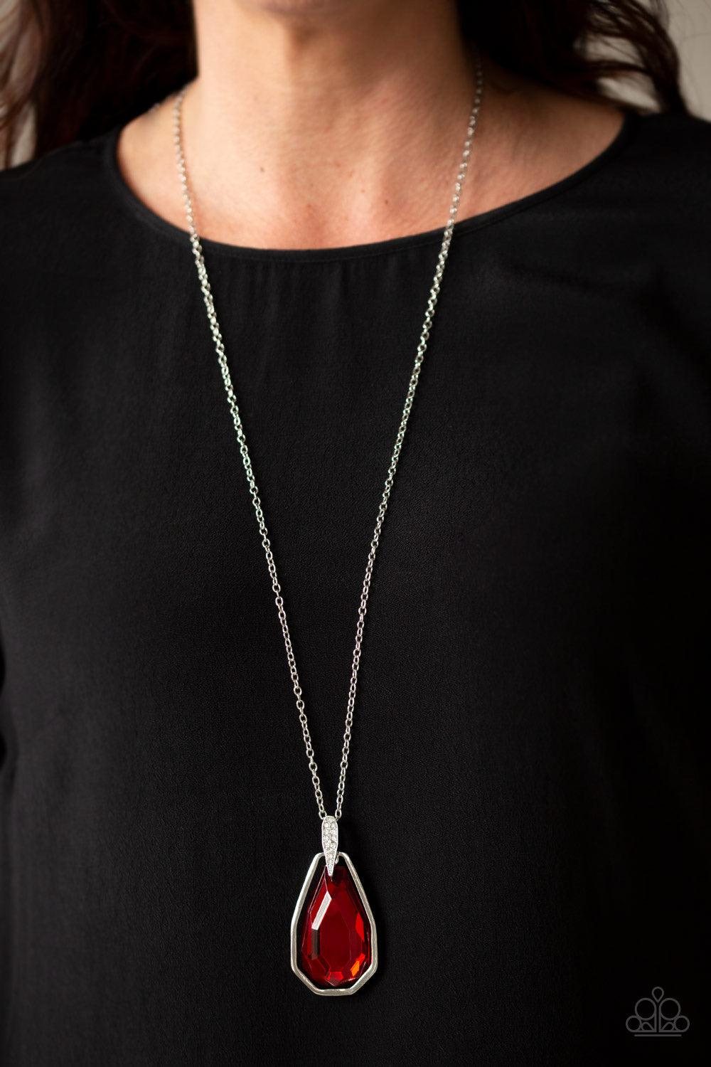 Paparazzi Accessories Maven Magic - Red A dramatically oversized red gem and edgy silver frame swing from a glassy white rhinestone fitting at the bottom of a lengthened silver chain for a glamorous look. Features an adjustable clasp closure. Jewelry