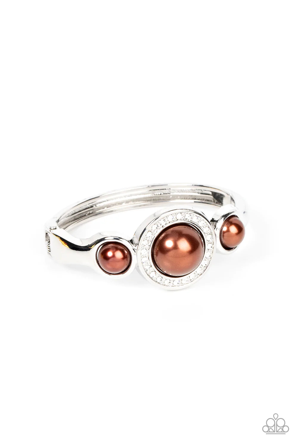 Paparazzi Accessories Debutante Daydream - Brown Encircled in a glitzy ring of glassy white rhinestones, an oversized brown pearl is flanked by a pair of bubbly brown pearl fittings atop a classic silver bangle-like bracelet for a timeless twist. Features
