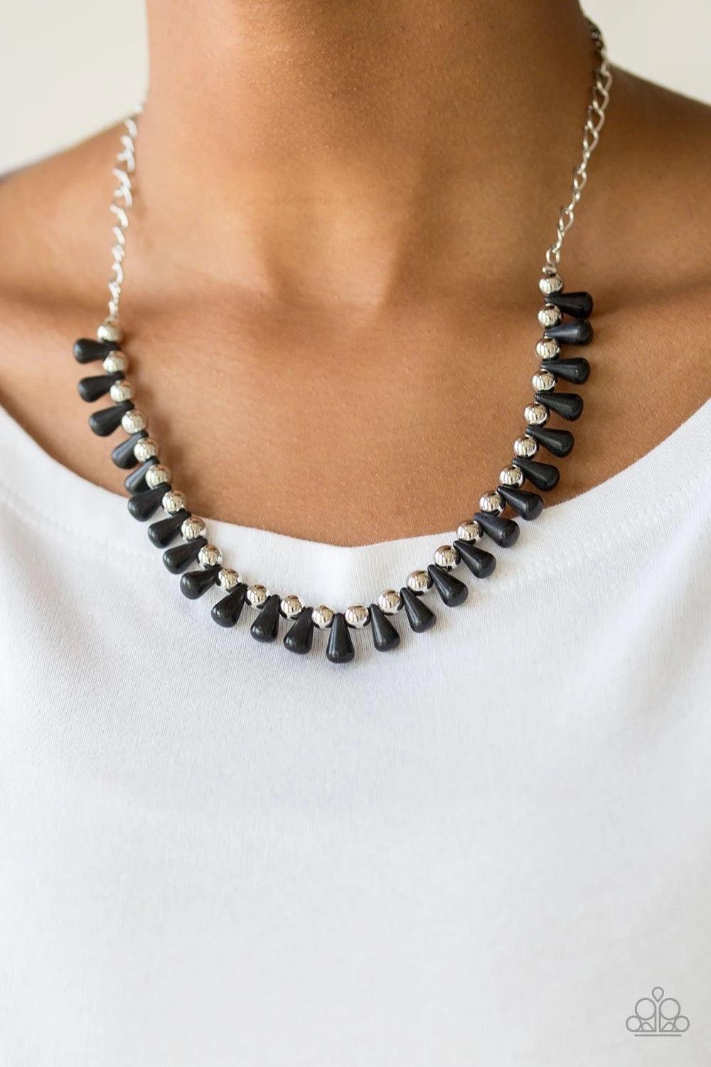 Paparazzi Accessories Extinct Species - Black Black teardrop stones and classic silver beads are threaded along an invisible wire. The earthy beads alternate below the collar, creating a wild fringe. Features an adjustable clasp closure. Sold as one indiv