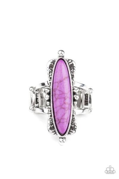 Paparazzi Accessories Cottage Craft - Purple An oblong purple stone is pressed into a flared silver frame featuring studded accents, creating an abstract centerpiece atop the finger. Features a stretchy band for a flexible fit. Sold as one individual ring