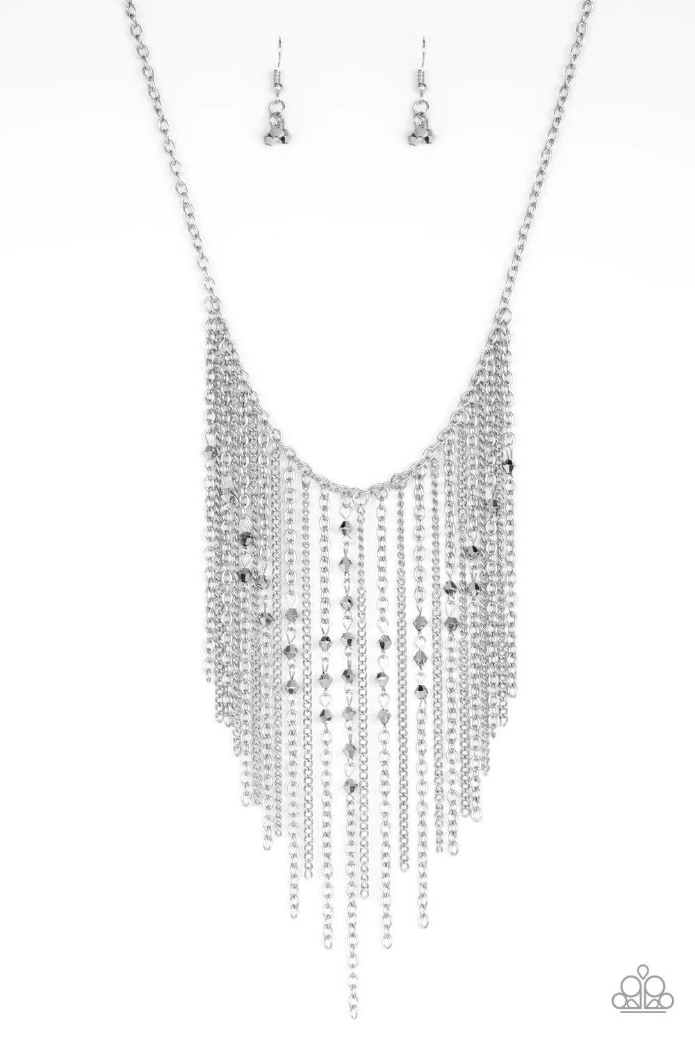 Paparazzi Accessories First Class Fringe - Silver Varying in length, mismatched silver chains stream from the bottom of a classic silver chain. Faceted hematite crystal-like beads sporadically dot the free-falling chains, creating a statement-making fring