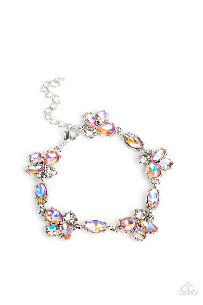Paparazzi Accessories Colorful Captivation - Orange Featuring various cuts and finishes, dainty clusters of white, pink, and orange iridescent rhinestones delicately link with marquise cut rhinestones around the wrist for an effervescent elegance. Feature