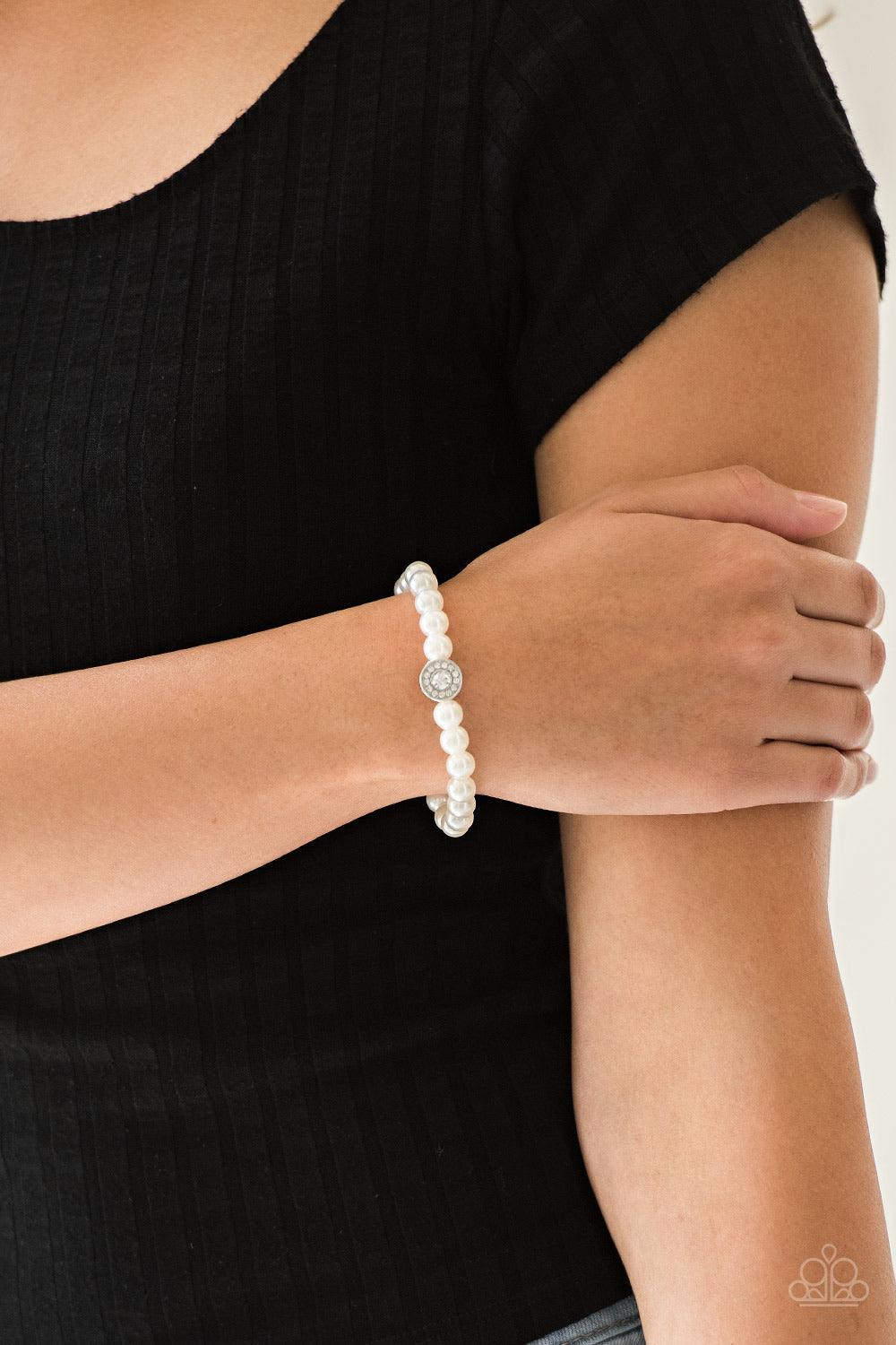 Paparazzi Accessories Follow My Lead - White White pearls and a white rhinestone encrusted silver charm are threaded along a stretchy band, creating a glamorous centerpiece atop the wrist. Jewelry