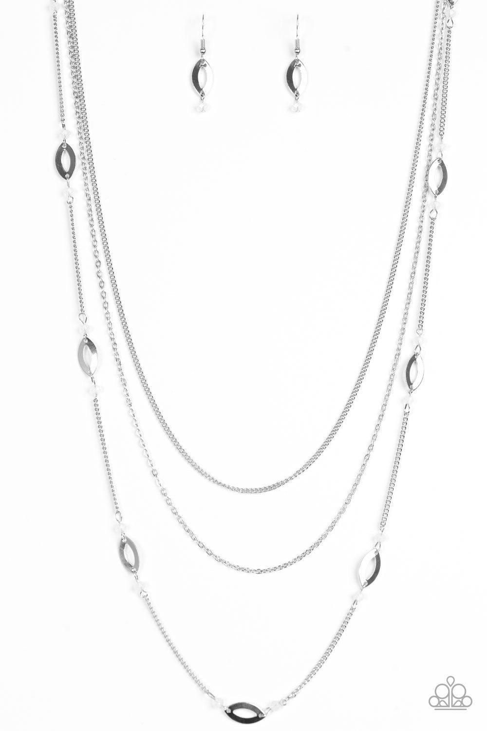 Paparazzi Accessories Afternoon Glow - White Mismatched silver chains layer down the chest. Sections of shimmery silver marquises frame and glowing white beads trickle along the centermost chain for a seasonal finish. Features an adjustable clasp closure.