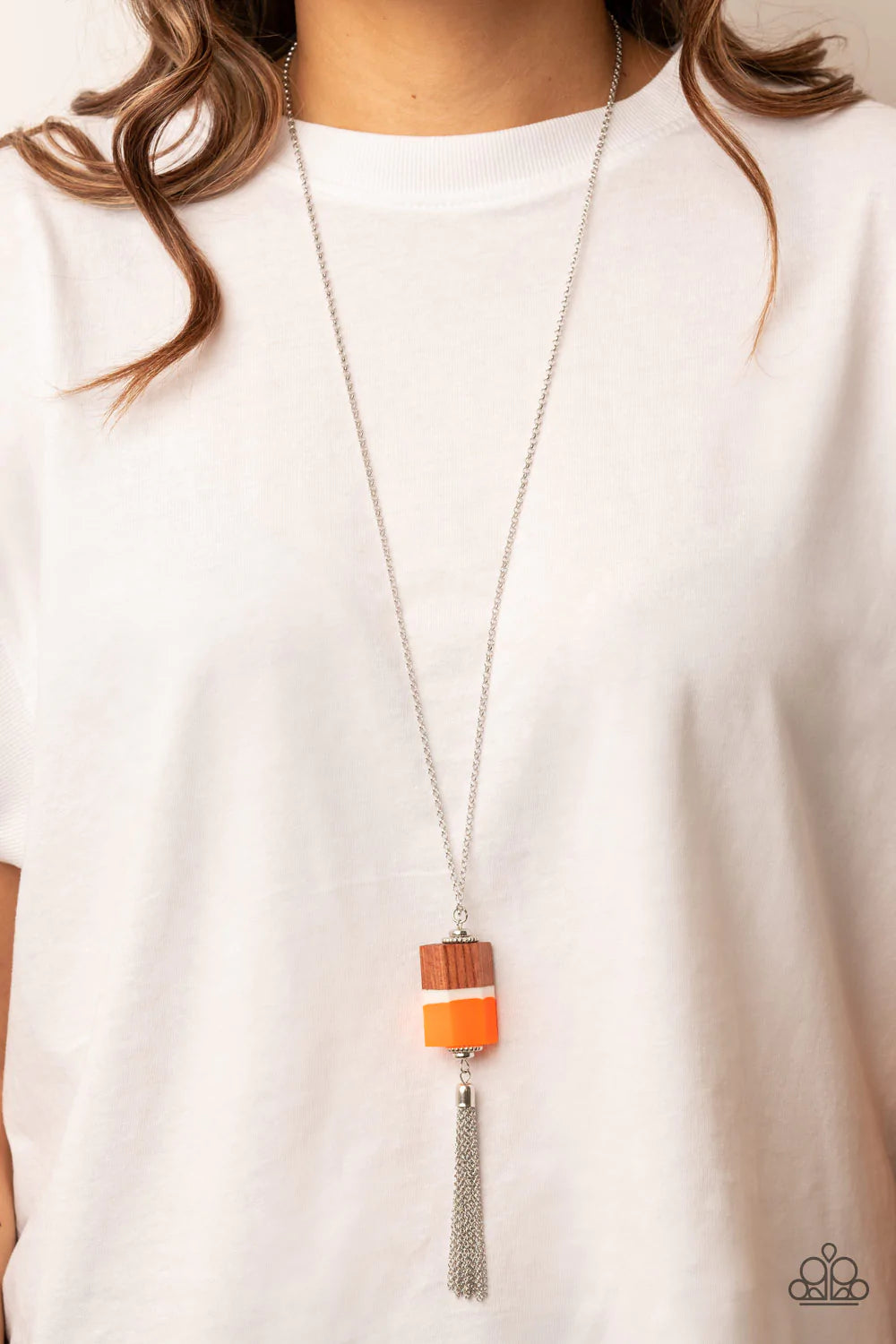 Paparazzi Accessories Reel It In - Orange Infused with silver beaded accents, pieces of orange and brown wood and a white acrylic accent delicately stack into a faceted geometric pendant at the bottom of an extended silver chain. A shimmery silver chain t