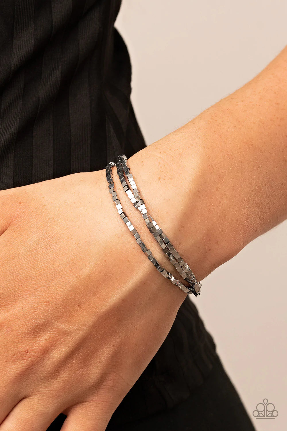 Paparazzi Accessories Block Bash - Silver A dainty collection of silver cube beads alternates along stretchy bands, stacking into edgy layers around the wrist. Sold as one set of three bracelets. Jewelry