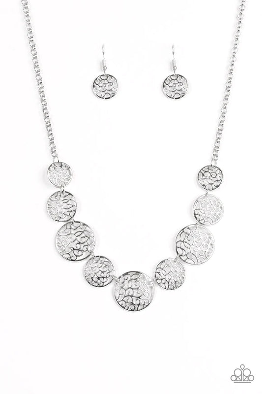 Paparazzi Accessories All The Time In The Whirl - Silver Filled with whirling filigree centers, shiny silver frames link below the collar for a whimsical look. Features an adjustable clasp closure. Sold as one individual necklace. Includes one pair of mat