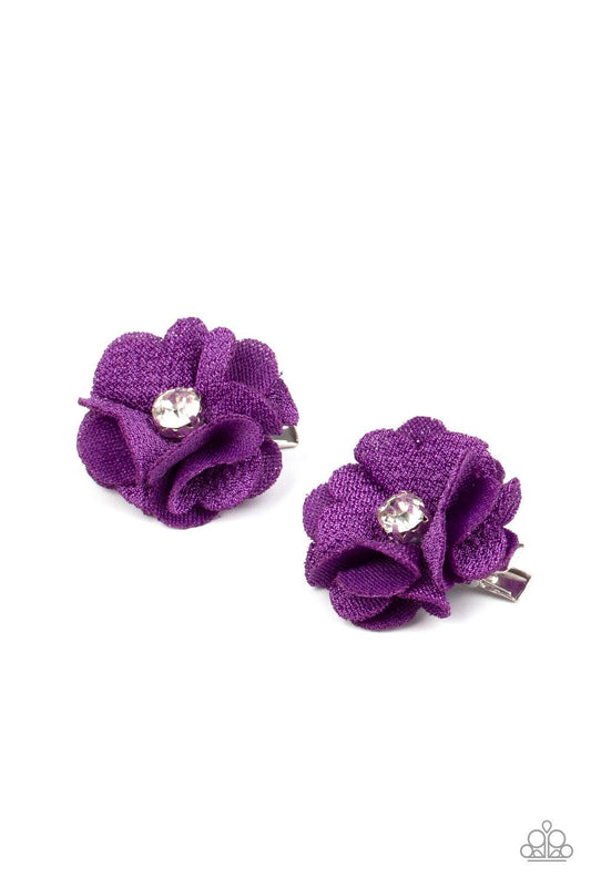 Paparazzi Accessories Watch Me Bloom - Purple Textured purple petals bloom from a glittery white rhinestone center, creating a charming pair of colorful blossoms. Each flower features a standard hair clip on the back. Sold as one pair of hair clips. Hair