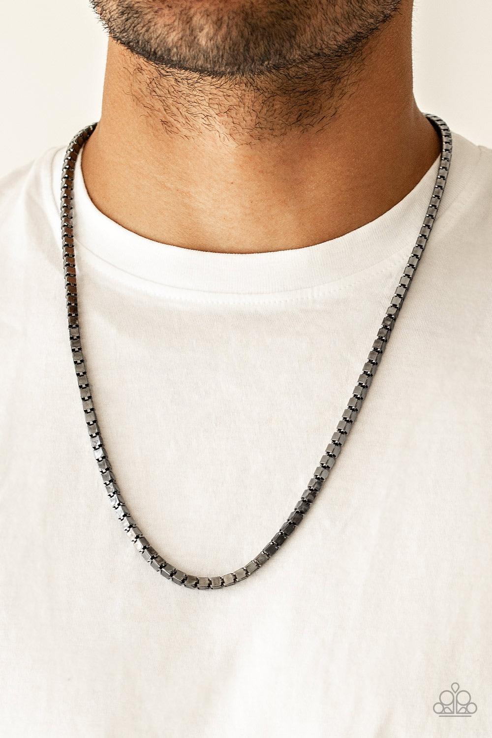 Paparazzi Accessories Boxed In - Black A thick strand of glistening gunmetal box chain drapes across the chest for a bold look. Features an adjustable clasp closure. Jewelry