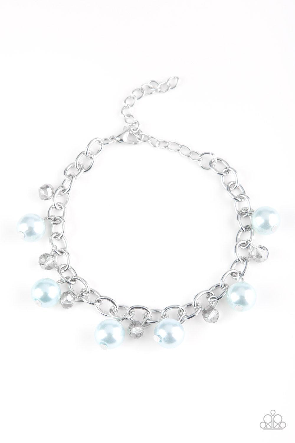 Paparazzi Accessories Country Club Chic - Blue Classic blue pearls and smoky crystal-like beads dangle from a shimmery silver chain, creating a refined fringe around the wrist. Features an adjustable clasp closure. Jewelry