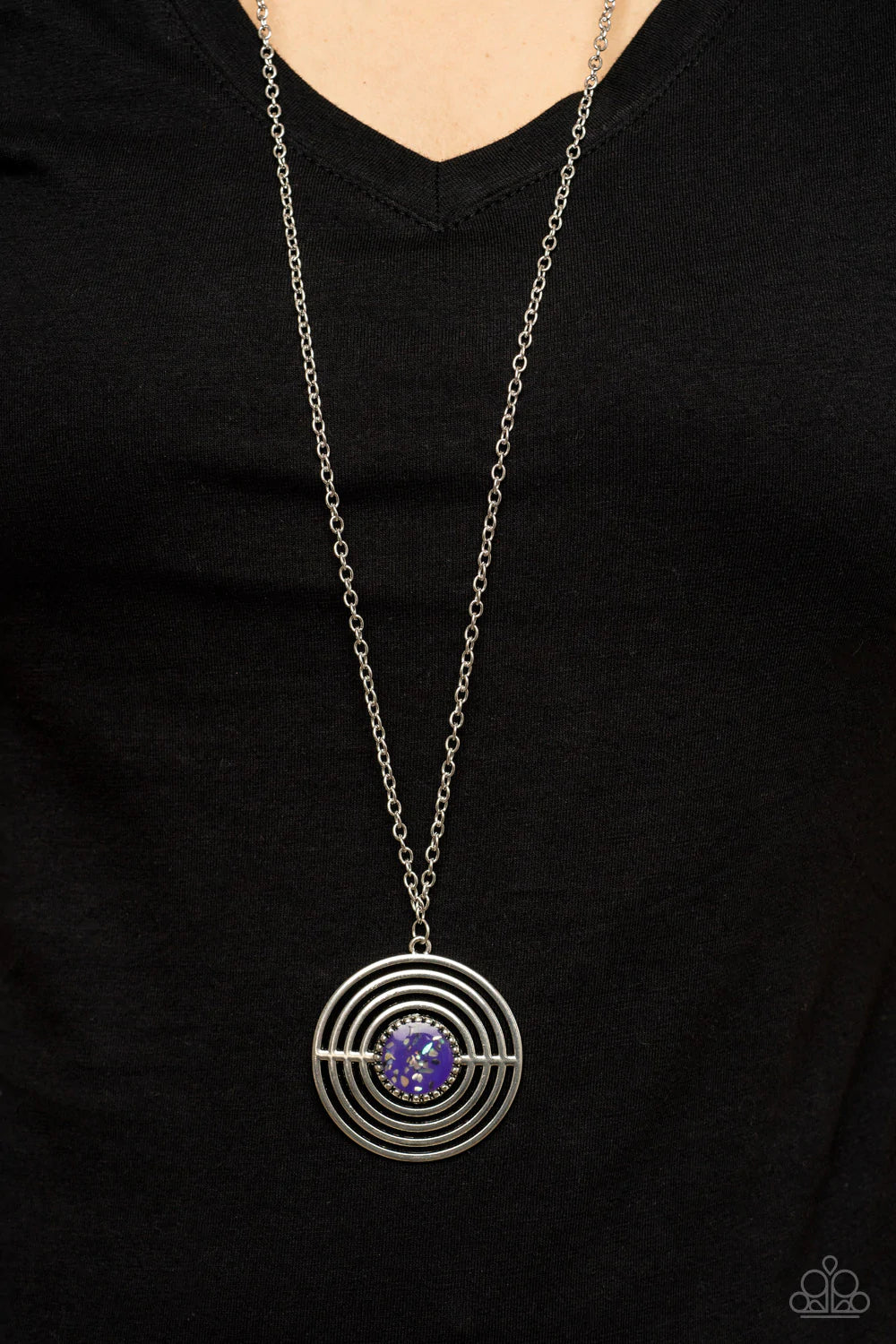 Paparazzi Accessories Targeted Tranquility - Purple Flecked in iridescent shell-like accents, a studded purple frame adorns the center of an oversized silver pendant rippling with concentric circles at the bottom of an extended silver chain for a dizzying