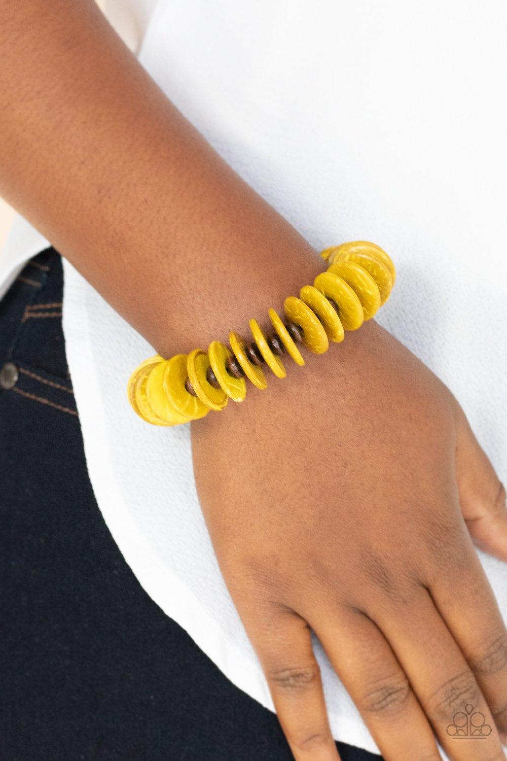 Paparazzi Accessories Caribbean Reels - Yellow White wooden beads and distressed yellow wooden discs alternate along a stretchy band around the wrist, creating a colorful pop of summer flavor. Jewelry