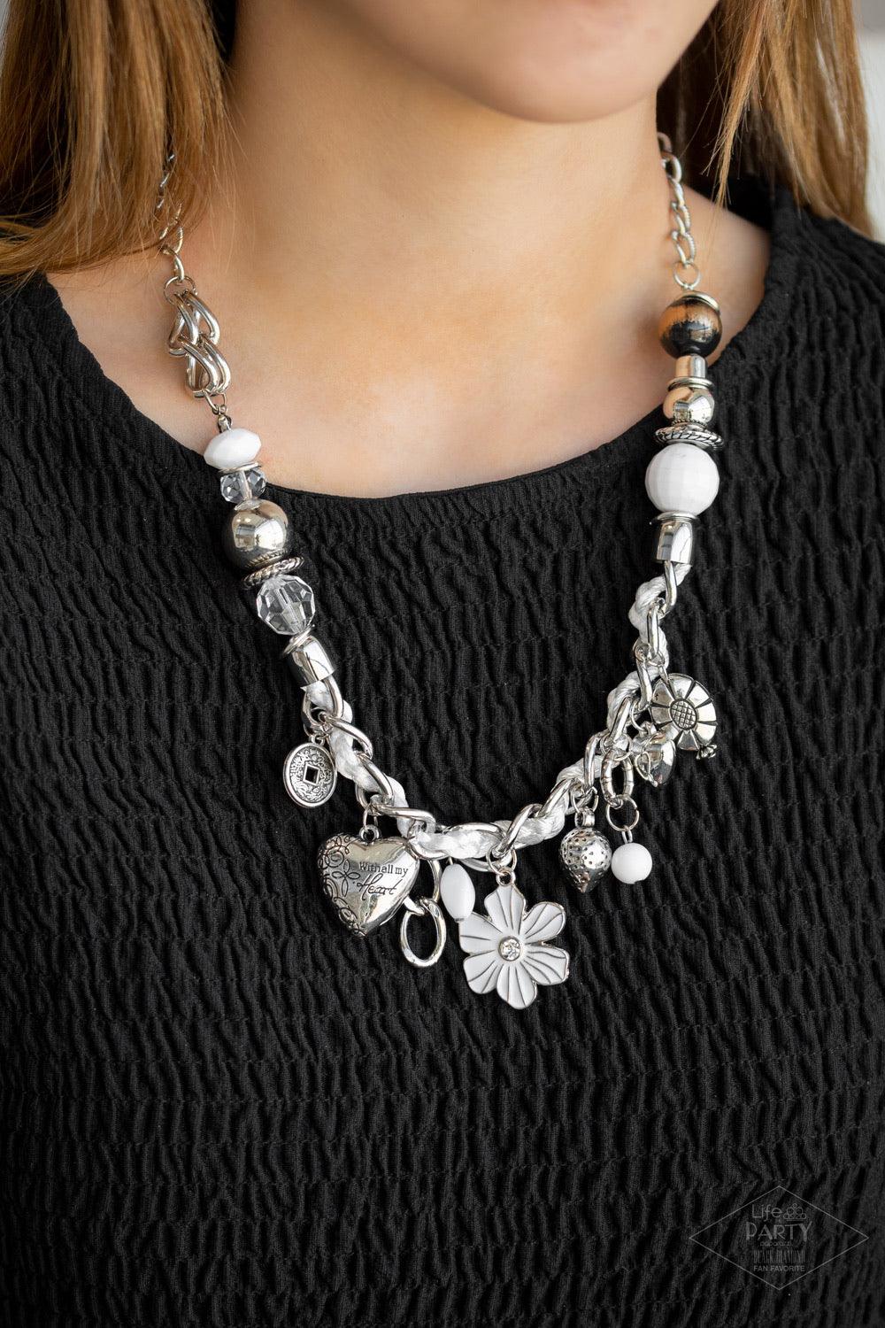 Paparazzi Accessories Charmed, I Am Sure - White White and ivory cording is braided through a chunky silver chain. A unique variety of charms decorate the piece including a delicate flower and a heart inscribed with the phrase "With All My Heart" on one s