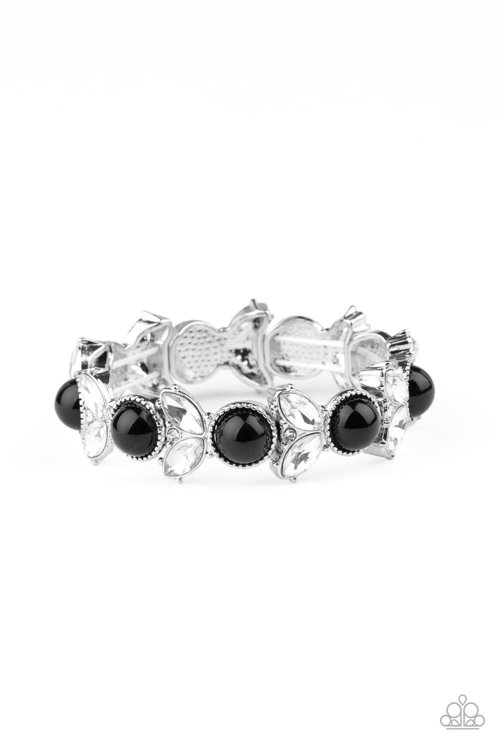 Paparazzi Accessories Opulent Oasis - Black Encrusted in dazzling white rhinestones and an oversized black bead, leafy silver frames are threaded along stretchy bands around the wrist for a timeless look. Sold as one individual bracelet. Jewelry
