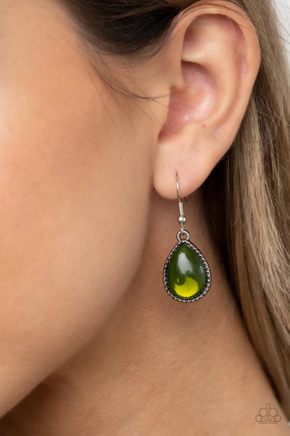 Paparazzi Accessories Opal Auras - Green Featuring an opalescent shimmer, glassy Military Olive teardrop beads are nestled inside shiny silver frames filled with vine-like antiqued filigree. Graduating in size, the whimsical frames delicately link below t