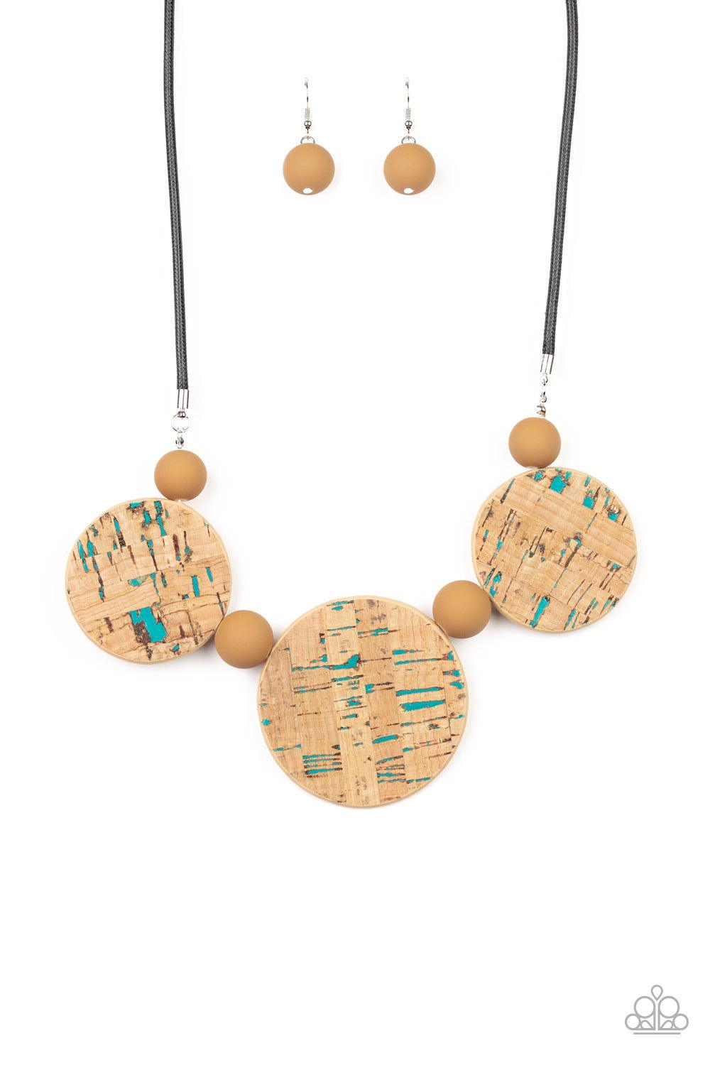 Paparazzi Accessories Pop The Cork - Blue Featuring blue accents, cork-like frames and brown matte beads are threaded along an invisible wire below the collar for a statement-making look. Features an adjustable clasp closure. Sold as one individual neckla