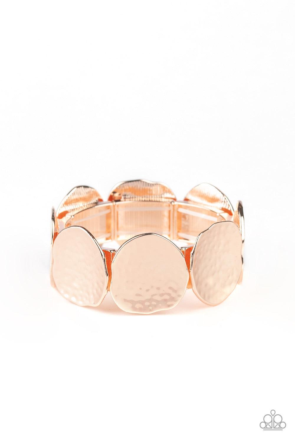 Paparazzi Accessories Treasure Cache - Gold Delicately hammered in shimmer, asymmetrical rose gold discs are threaded along a stretchy band around the wrist for an edgy look. Jewelry