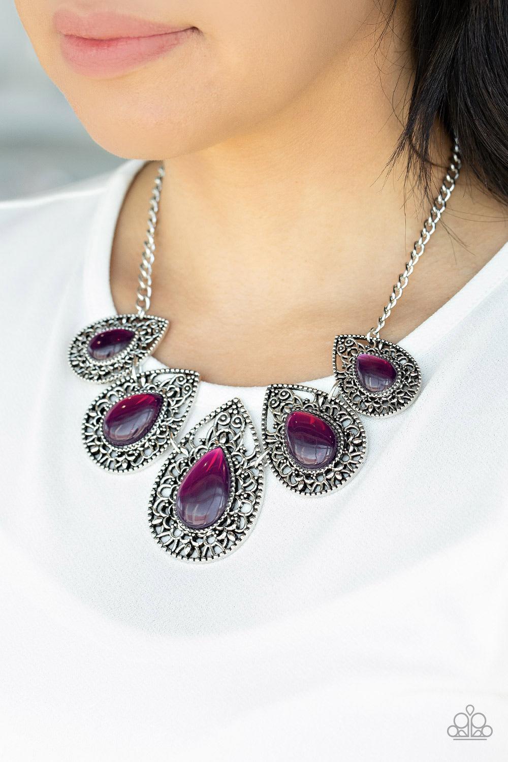 Paparazzi Accessories Opal Auras Featuring an opalescent shimmer, glassy purple teardrop beads are nestled inside shiny silver frames filled with vine-like antiqued filigree. Graduating in size, the whimsical frames delicately link below the collar for an