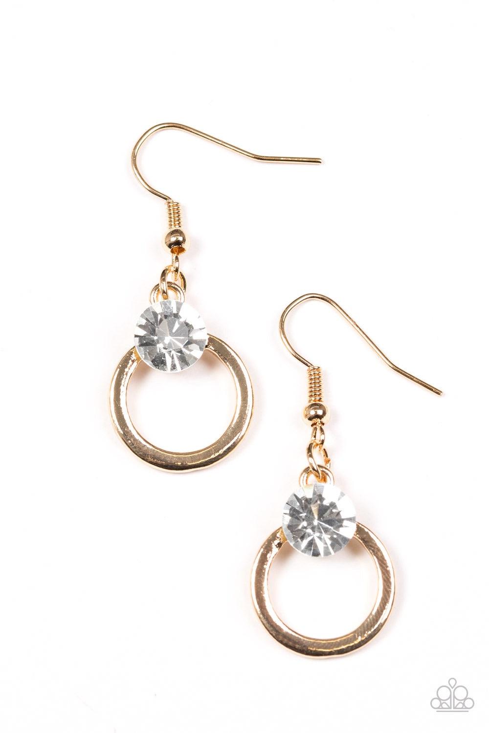 Paparazzi Accessories FAME On - Gold An oversized white rhinestone crowns the top of a glistening gold hoop for a refined look. Earring attaches to a standard fishhook fitting. Jewelry