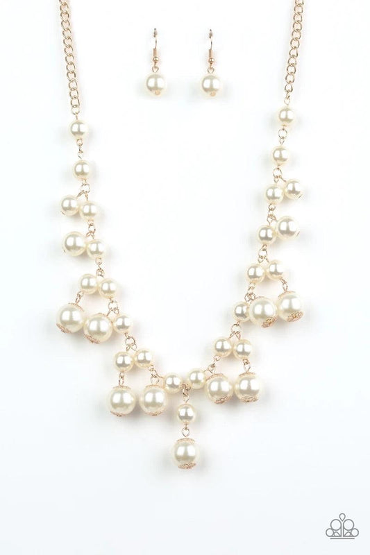Paparazzi Accessories Soon To Be Mrs - Gold Varying in size, bubbly white pearls swing from the bottom of a classic strand of pearls, creating a refined fringe below the collar. Features an adjustable clasp closure. Sold as one individual necklace. Includ
