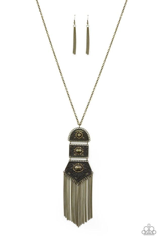 Paparazzi Accessories Tassel Tycoon - Brass Brass beads encircled by topaz rhinestones are nestled inside a row of three vintage frames that cascade down the chest at the bottom of an elongated brass chain. Glistening brass chains stream from the bottom o