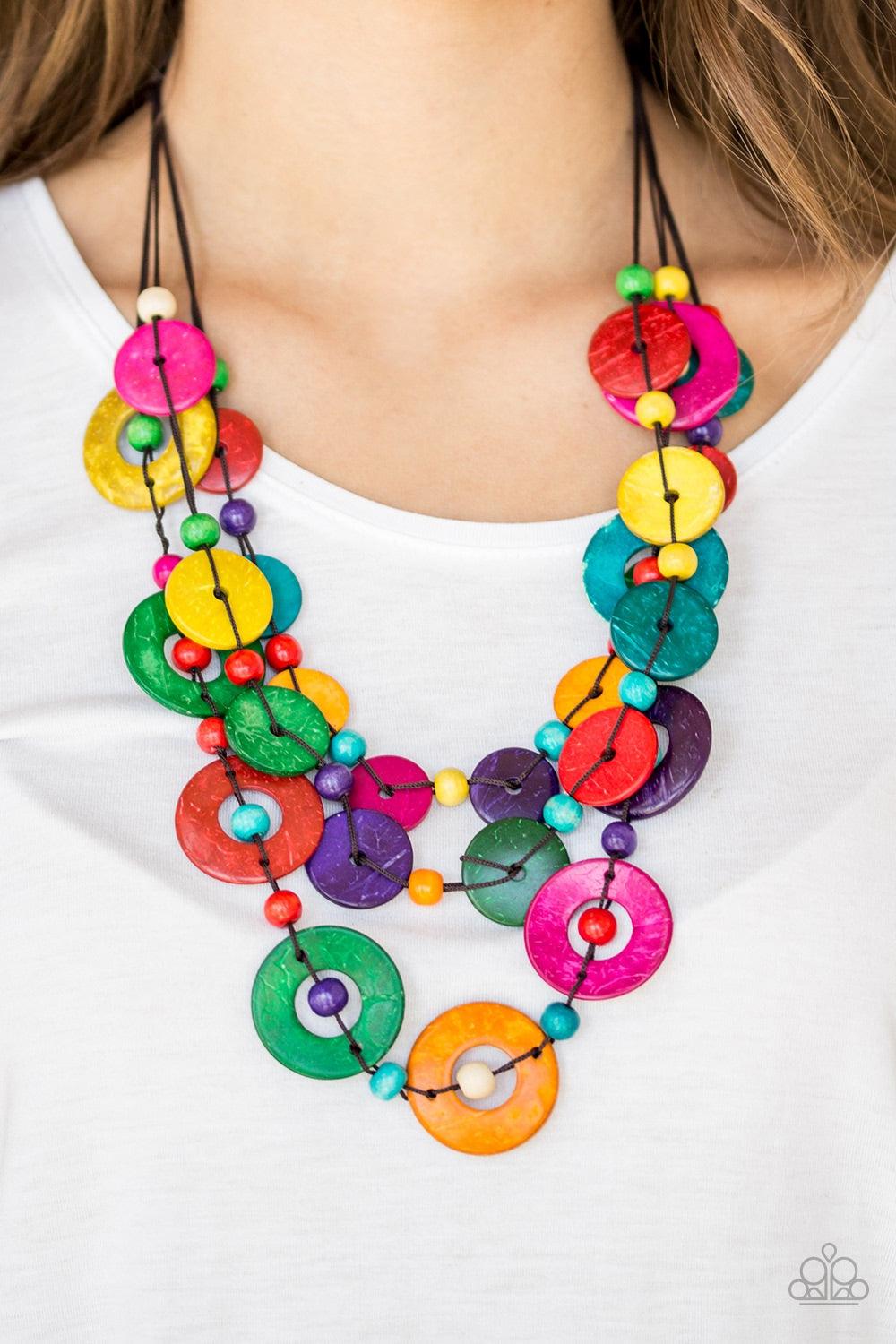 Paparazzi Accessories Catalina Coastin - Multi Brushed in a shell-like iridescence, vivacious multicolored wooden discs and round multicolored wooden beads are knotted along three strands of brown cording for a summery look. Features a button loop closure