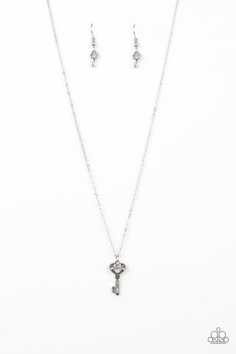 Paparazzi Accessories Lock Up Your Valuables - White Dotted in glassy white rhinestones, a dainty silver key pendant swings below the collar for a charming look. Features an adjustable clasp closure. Jewelry