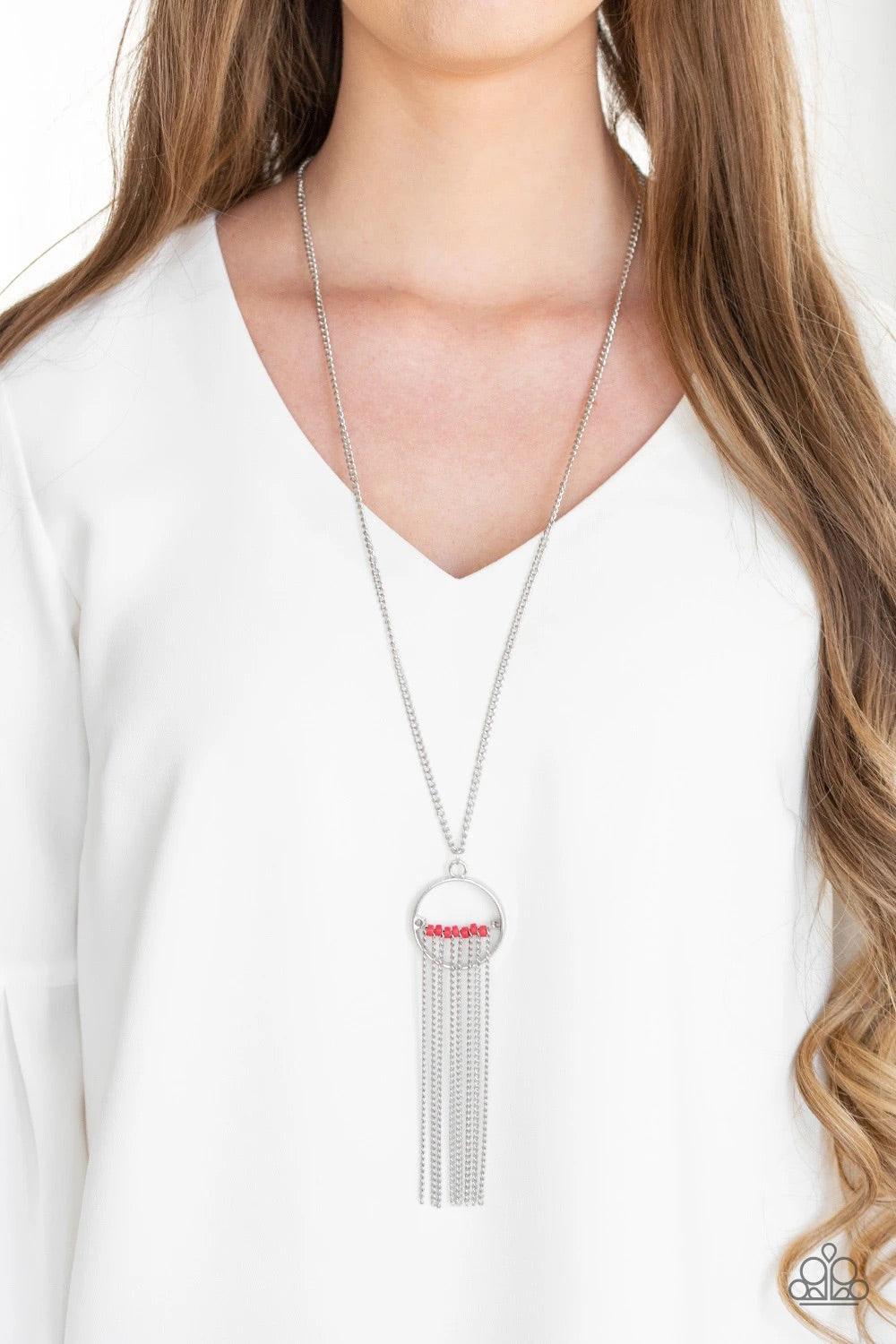 Paparazzi Accessories Terra Tassel - Red Infused with a shimmery silver chain fringe, a row of red beads is threaded along a silver rod that is fitted in place inside the center of an airy silver ring. The colorful pendant swings from the bottom of a leng