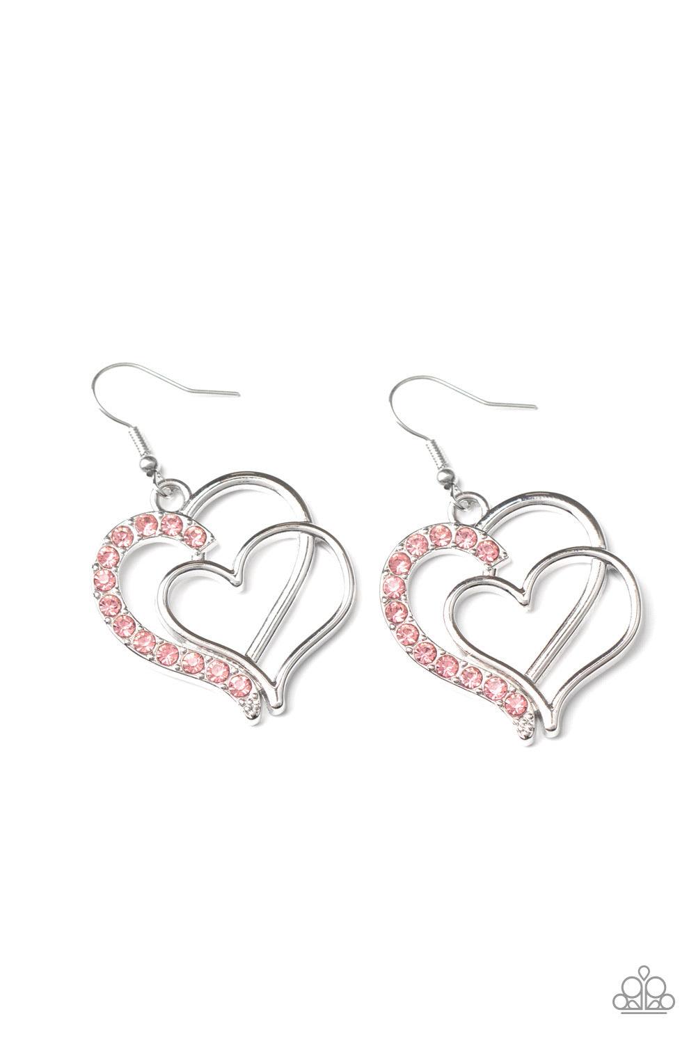 Paparazzi Accessories Double The Heartache - Pink Two shimmery silver hearts delicately overlap into a romantic frame. The edge of the largest heart is encrusted in a section of flirty pink rhinestones for a colorfully charming finish. Earring attaches to