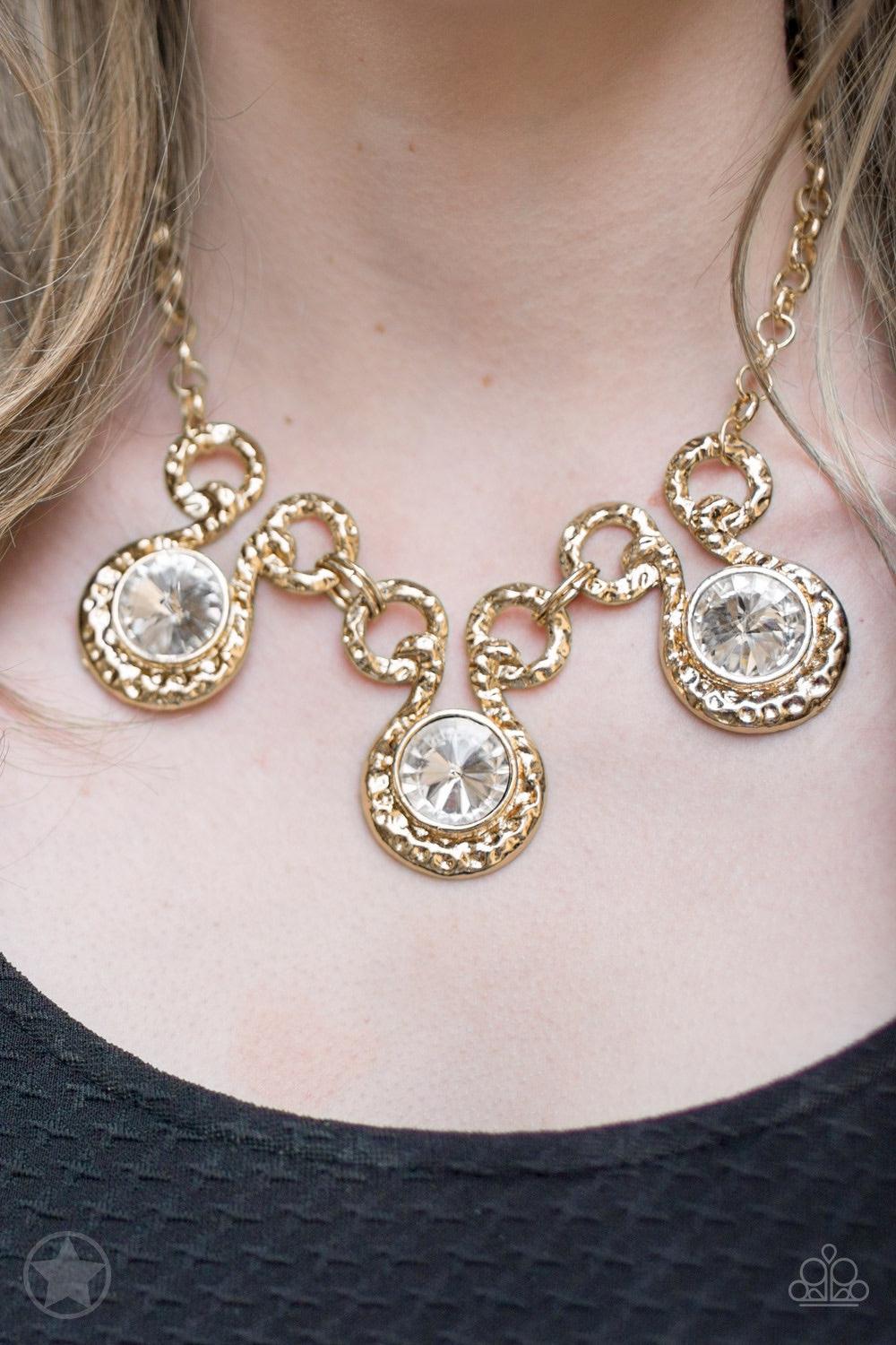 Paparazzi Accessories Hypnotized - Gold Three dramatically oversized rhinestones are nestled into three textured gold fittings that are connected by oval gold rings, creating a brilliant statement piece. Features an adjustable clasp closure. Jewelry