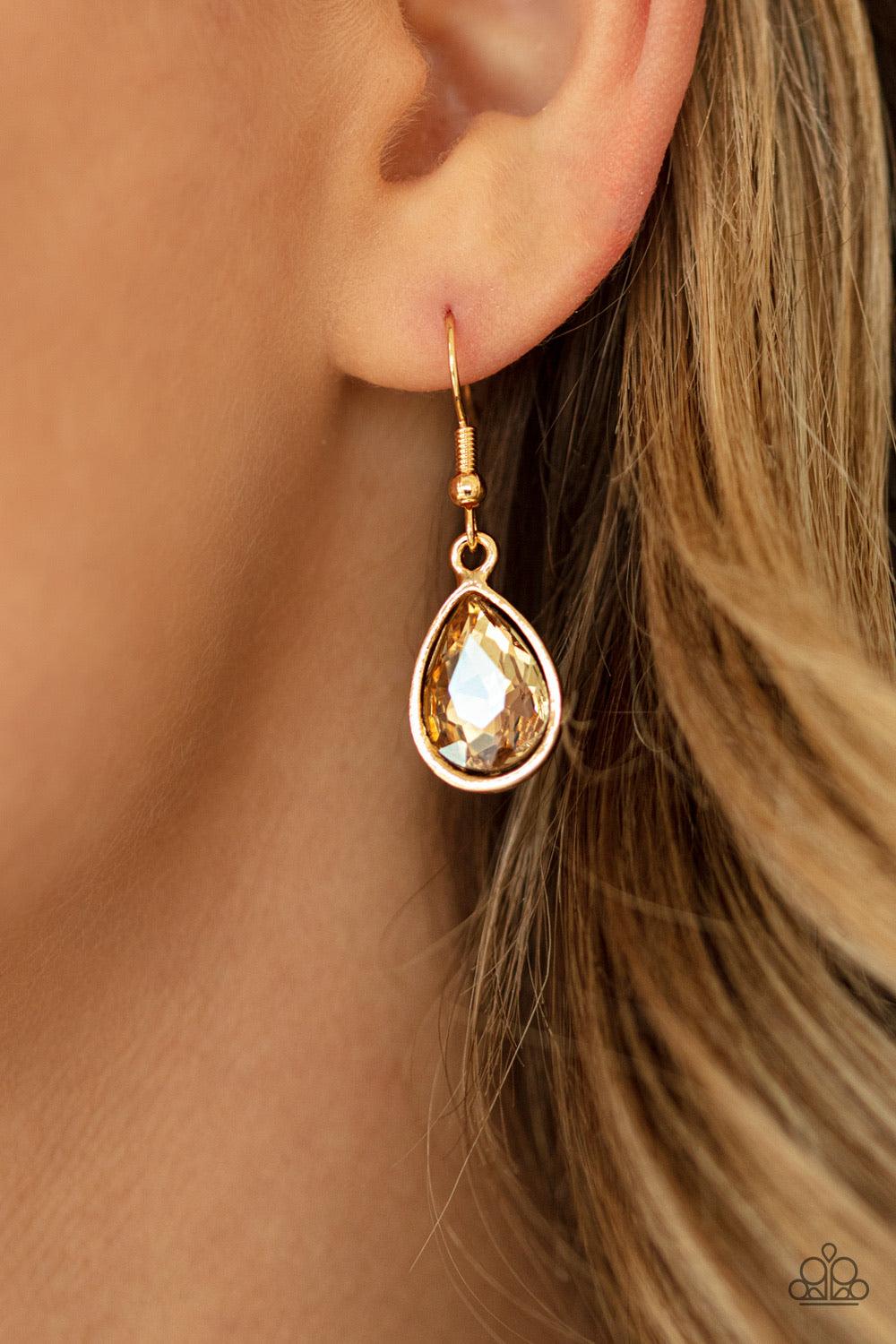 Paparazzi Accessories I Want It All - Gold A sassy combination of golden and white teardrop gems delicately link into a stunning piece below the collar. Dainty white rhinestones are scattered through the piece for unexpected hints of shimmer. Features an