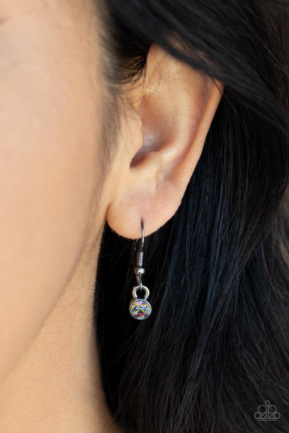 Paparazzi Accessories Unfathomable Fierceness - Multi A sparkly series of glassy oil spill rhinestones gives way to an oversized oil spill rhinestone teardrop pendant at the bottom of a dainty gunmetal chain. A lobster clasp hangs from the bottom of the d