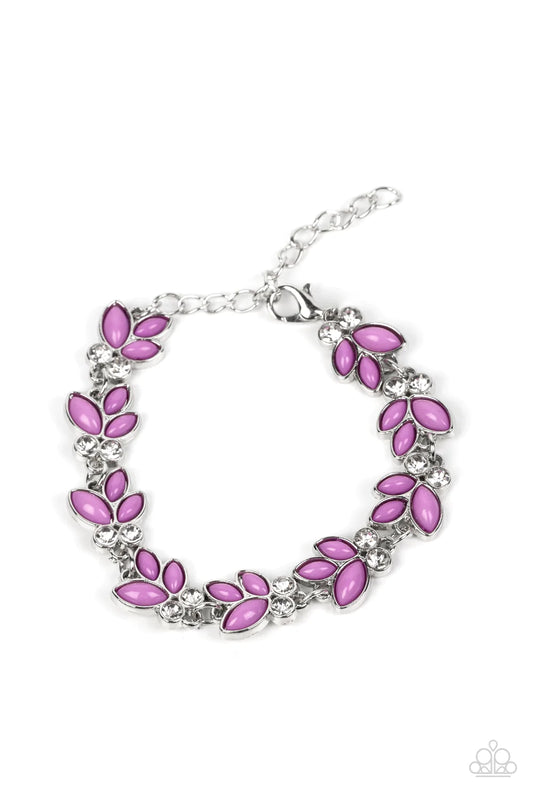 Paparazzi Accessories Vineyard Variety Trios of purple beads fan out from pairs of white rhinestones as they delicately link around the wrist, resulting in colorful leafy accents. Features an adjustable clasp closure. Sold as one individual bracelet.
