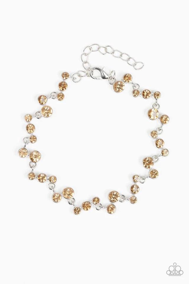 Paparazzi Accessories Starlit Stunner - Brown Varying in size, a collection of golden topaz rhinestones connect across the wrist for a timeless look. Features an adjustable clasp closure. Jewelry