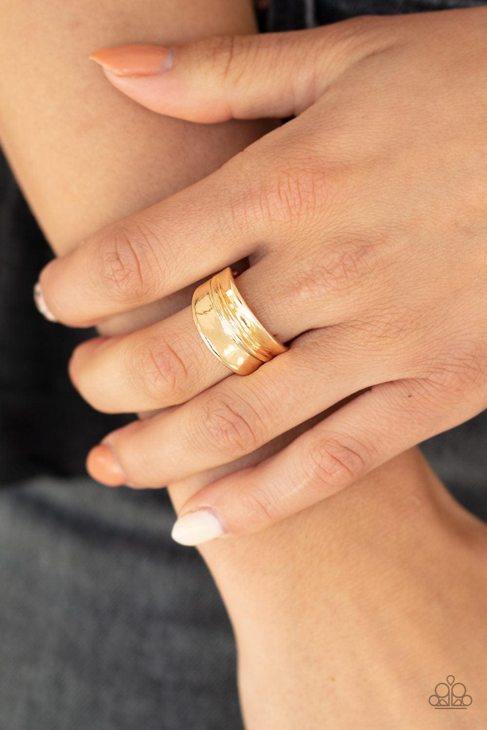 Paparazzi Accessories Band Together - Gold Brushed in a high-sheen finish, a rippling gold band arcs across the finger for a classic look. Features a dainty stretchy band for a flexible fit. Sold as one individual ring. Jewelry