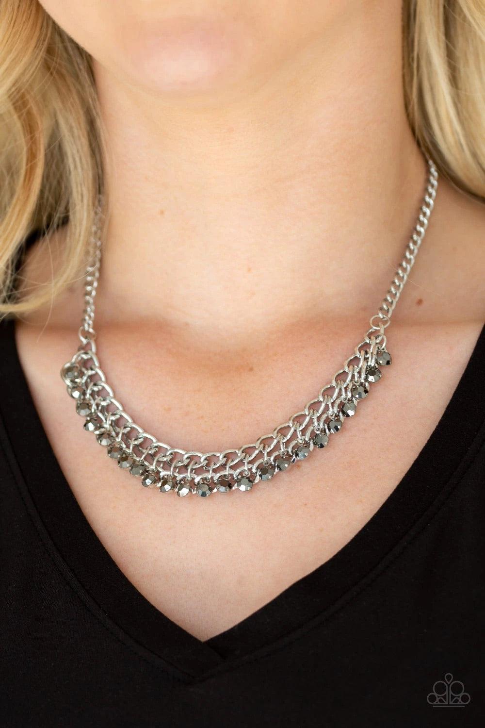 Paparazzi Accessories Glow And Grind - Silver A fringe of glittery hematite rhinestones swings from the bottom of a bold silver chain below the collar for a fierce look. Features an adjustable clasp closure. Sold as one individual necklace. Includes one p