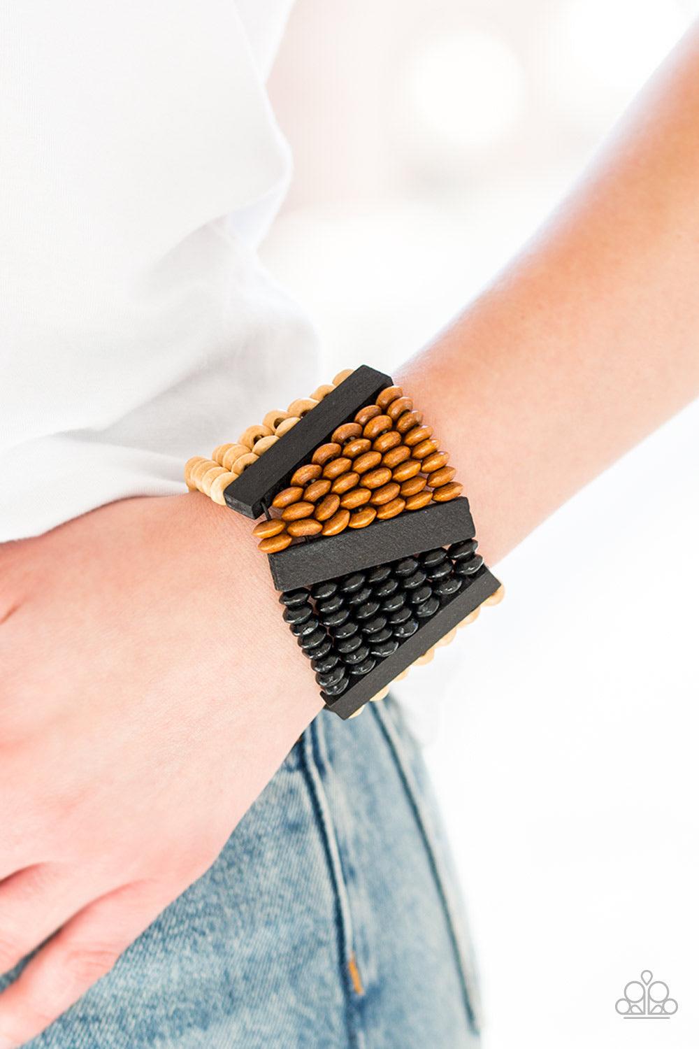 Paparazzi Accessories HAUTE In Hispaniola - Black A collection of round and rectangular wooden beads are threaded along stretchy bands, coalescing into an earthy beaded palette for a summery look. Sold as one individual bracelet. Jewelry