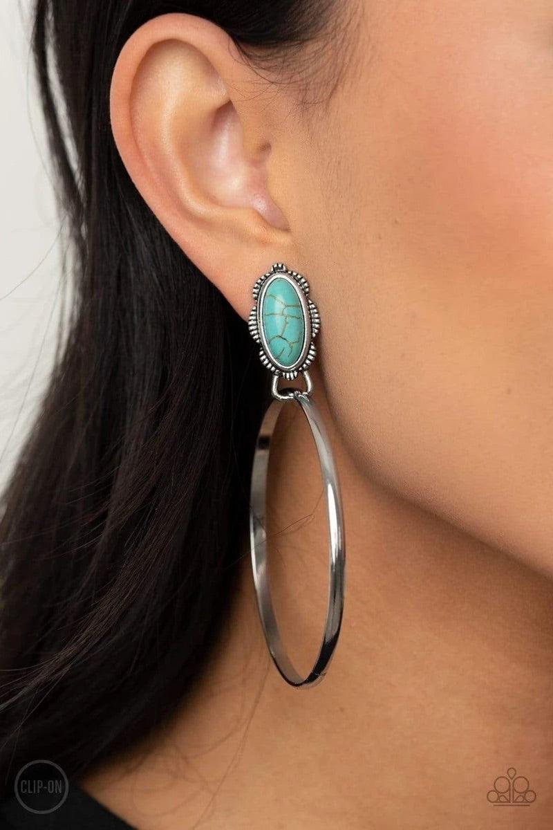 Paparazzi Accessories At Long LASSO - Blue *Clip-On A shimmery silver hoop is threaded through the bottom fitting of an earthy turquoise stone dotted floral silver frame, creating a whimsical display. Earring attaches to a standard clip-on fitting. Sold a