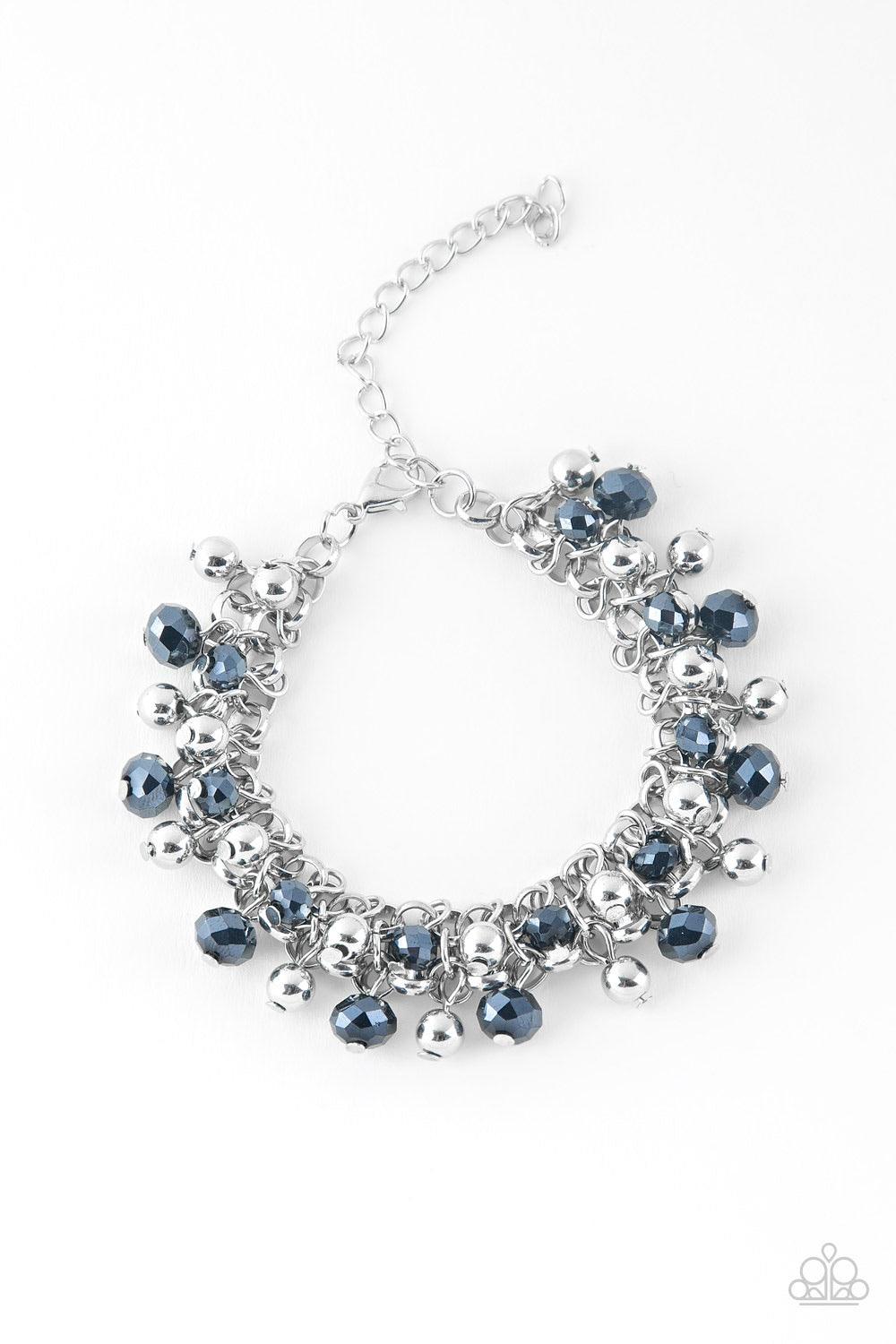 Paparazzi Accessories Just For The FUND Of It! - Blue Dipped in a metallic shimmer, faceted blue beads and classic silver beads swing from interlocking silver chains, creating a refined fringe around the wrist. Features an adjustable clasp closure. Sold a