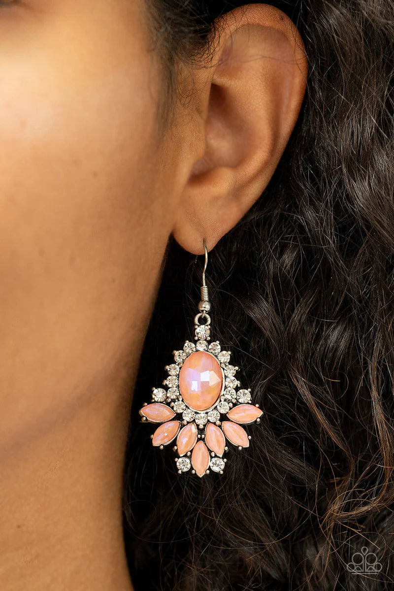 Paparazzi Accessories Magic Spell Sparkle - Orange Featuring a stellar opalescent finish, staggered layers of marquise cut coral rhinestones fan out from an oversized coral gem that is bordered in a ring of glittery white rhinestones for an enchanting fin
